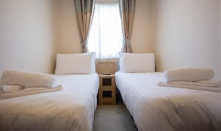 The twin bedroom at one of our bright and spacious indulgent static caravans. The perfect way to stay. image