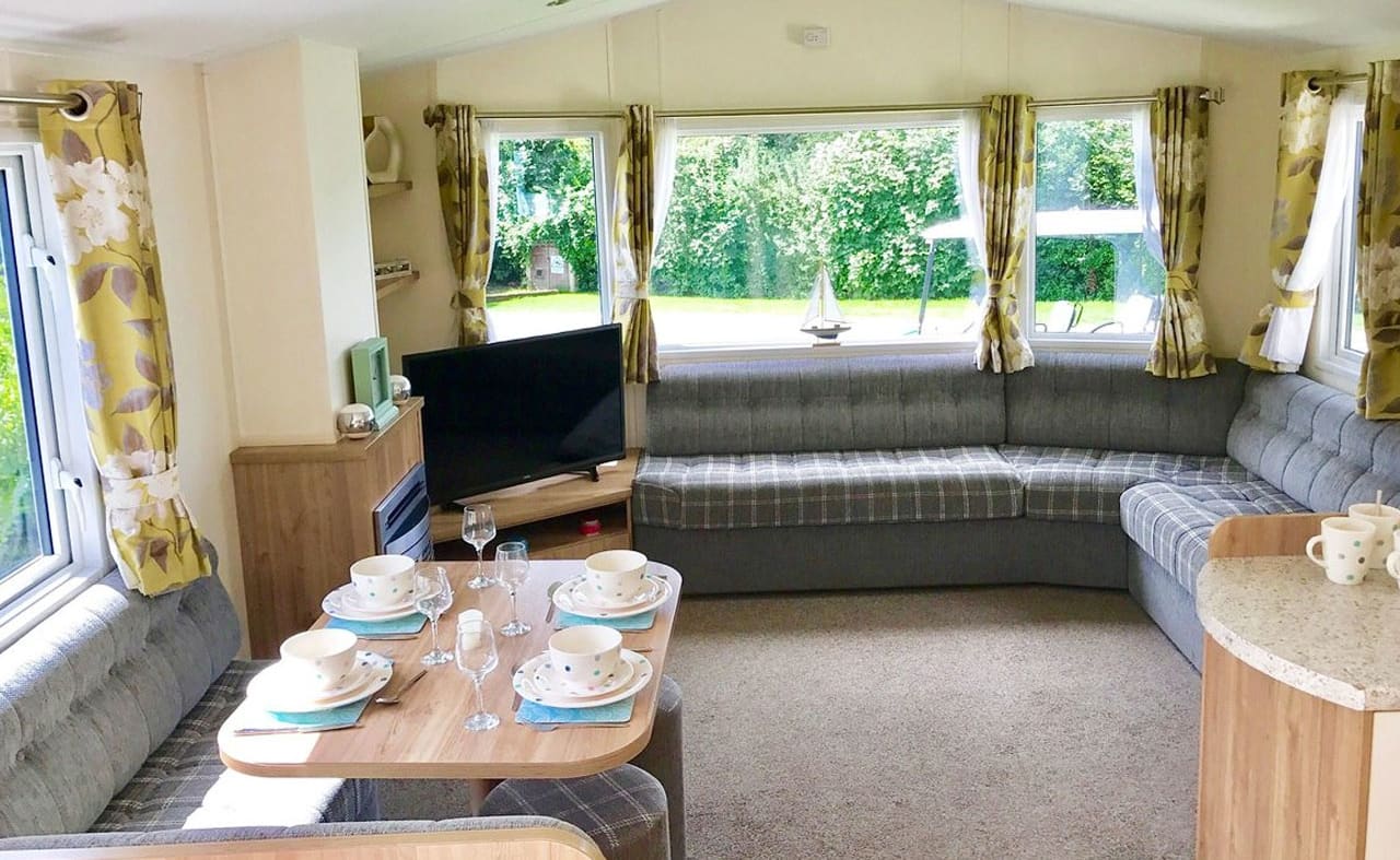 The lounge area of one of our Superior Caravans. Book your holiday now! image