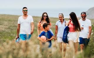 A family enjoying a peaceful stroll to the Cornish coastline on a summers day. image