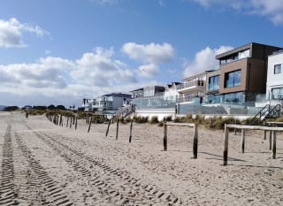 An image of Sandbanks Beach in Dorset. You can see the golden sand and houses overlooking the beach. image