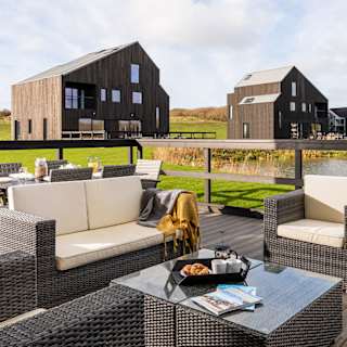 Exterior of barn area at Retallack Resort and Spa overlooking the lake and beautiful Cornish countryside.