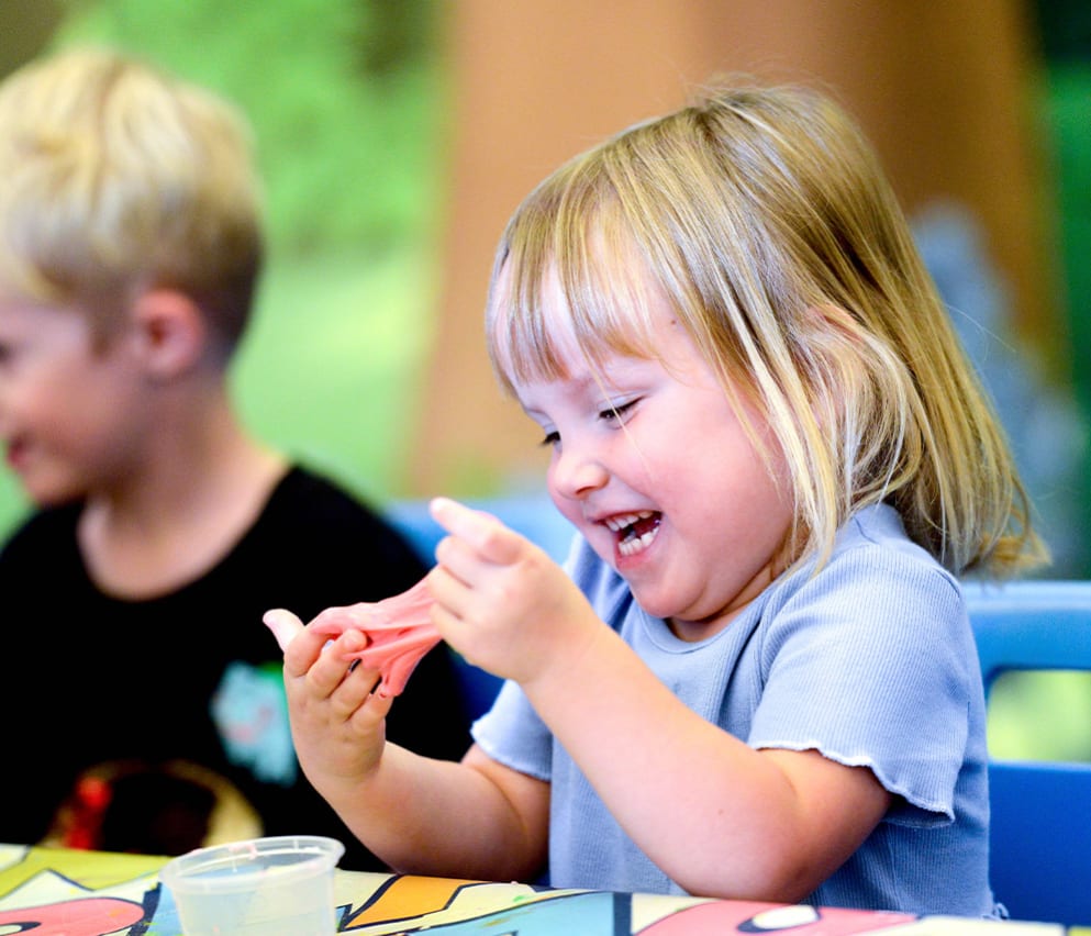 A young girl participating in our slime workshop activity.