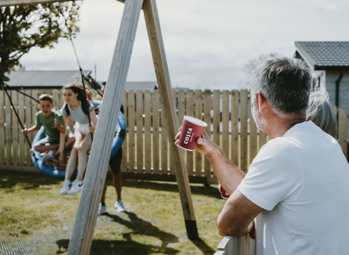 A family enjoying a summers day in the adventure playground at Bude Holiday Resort. image