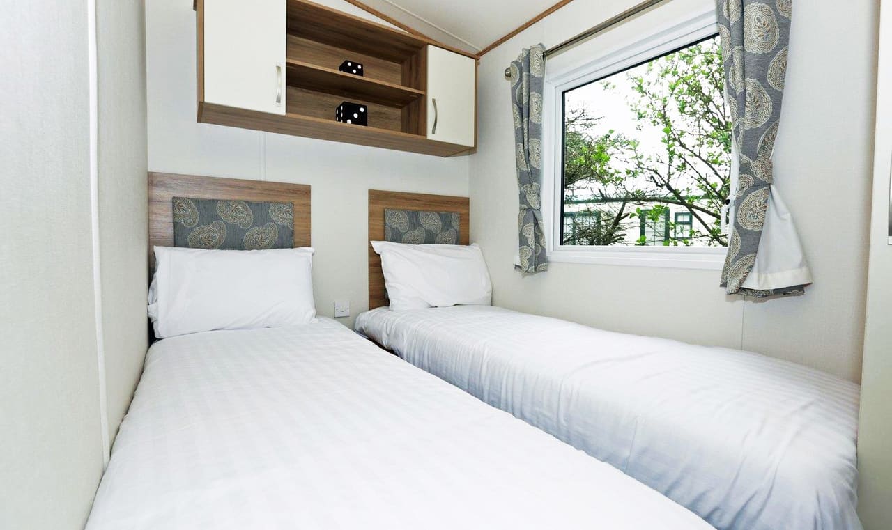 The twin bedroom of our bright and spacious luxury static caravan. The perfect way to stay. image