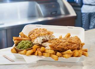 Fish and chips with a side of mushy peas at our Catch 22 venue. image