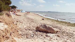 A hot summers day at the beach on Mersea Island, Essex. Book your caravan holiday with us.