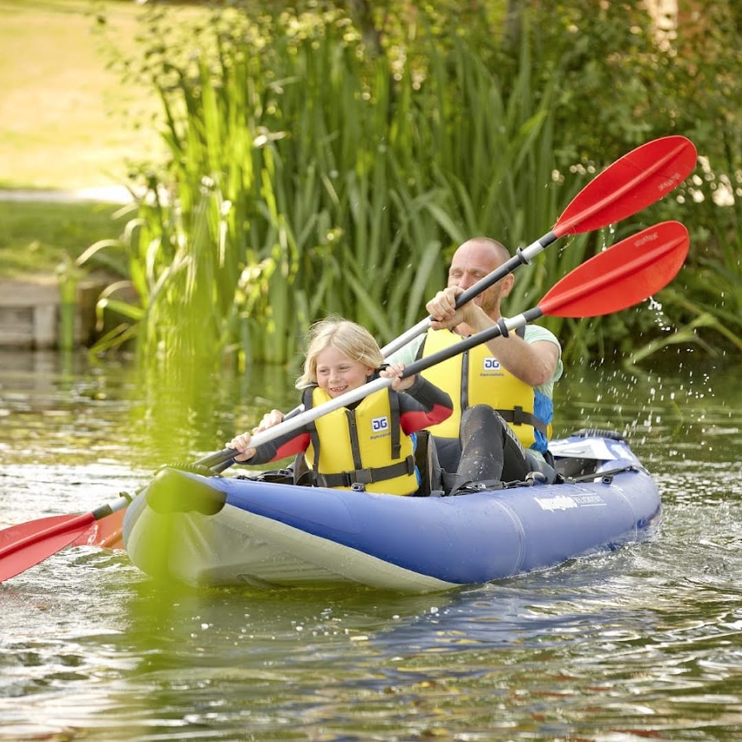 A man and child canoeing down the lake. image