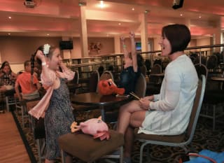 A family enjoying their evening at The Bar Carousel at Golden Sands Holiday Park. image