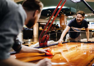 Two people playing in the arcade at our holiday park in North Wales, Golden Sands.