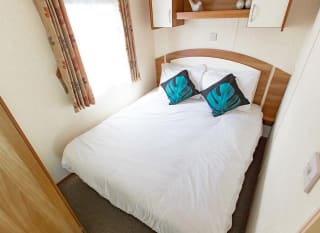 The double bedroom of our budget-friendly value static caravan. The perfect way to stay. image