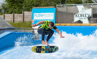 A man performing on our Retallack Resort and Spa FlowRider surfing machine. image