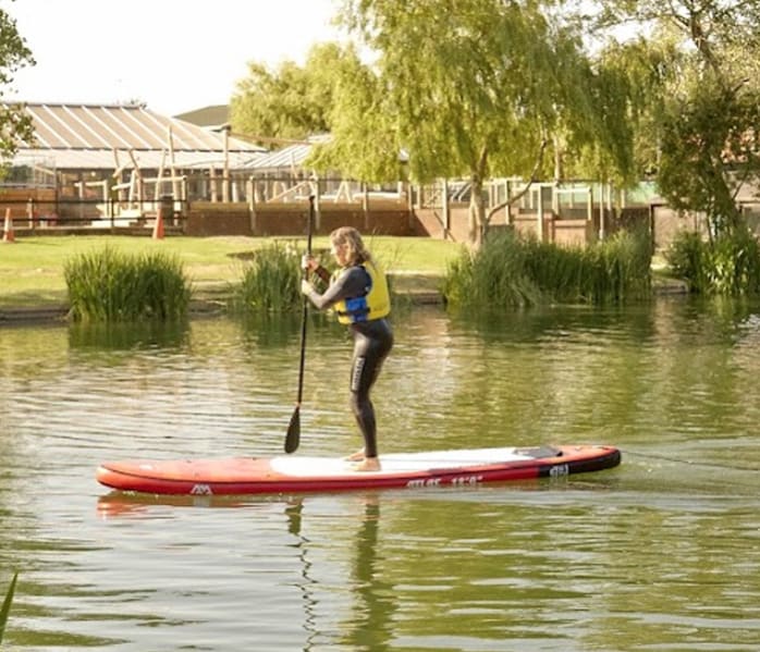 A group of people kayaking and canoeing on the lakes at The Lakes Rookley, Isle of Wight.