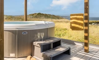 A bright sunny day at our St Ives park with stunning views from our hot tubs. image