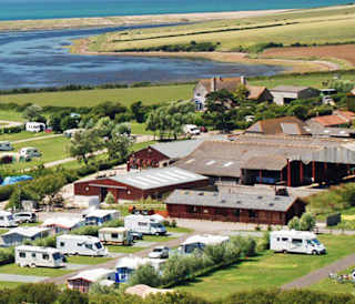 A drone image of our camping and touring park in Dorset, East Fleet Farm with views of the lagoon.