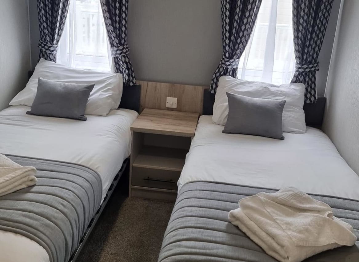 The twin bedroom of one of our exclusive accommodations, The Seaview Lodge. Book your holiday now! image