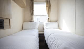 The twin bedroom of one of our budget-friendly value static caravans. The perfect way to stay. image
