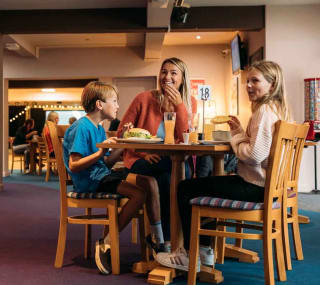 Family enjoying a bite to eat at our Newquay Bay Holiday Park. image