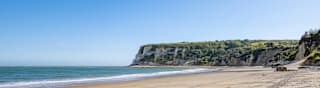 A bright and sunny day at a coastal cliff beach. image
