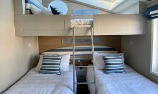 Twin bedroom with bunks at of one of our spacious static caravans in St Ives. Book your holiday now! image
