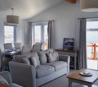 The living area of our bright and spacious Superior Lodge with stunning seaviews. The perfect way to stay. image