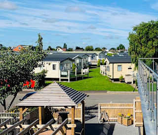 The view from the balcony of a row of static caravans on a sunny day at our stunning park, Cleethorpes Pearl.