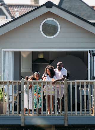 A family on the decking looking out onto the lake at our stunning resort, The Bay Filey.