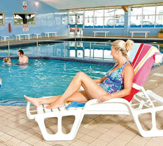 A young family playing in our indoor pool at our caravan holiday park Golden Sands, North Wales. image