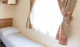 The twin bedroom of our budget-friendly value static caravan. The perfect way to stay. image