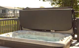 The decking with a hot tub of one of our stunning accommodations at St Helens Coastal Resort. image