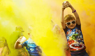 A colour festival event at one of our holiday parks. The young children are splashing colourful substances into the air at our incredible event. image