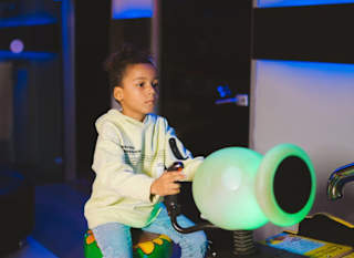 An image of a child playing in the arcade at one of our holiday parks. image