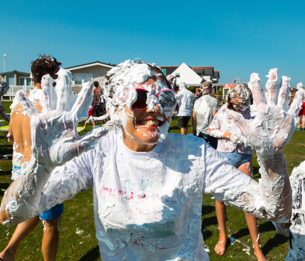 A hot summer day with a group of people covered in custard pie! As part of the many events and activities we offer at our holiday parks.