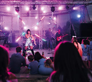 A women performing live on stage. image