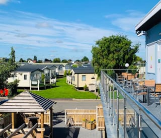 The view from the balcony of a row of static caravans on a sunny day at our stunning park, Cleethorpes Pearl.