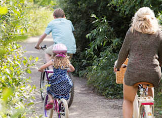 A family enjoying a day exploring the woods on their bikes. image