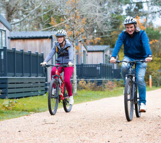 An image of two people cycling through on of our parks together. image
