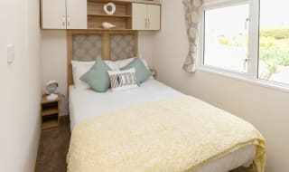 The double bedroom of our bright and spacious luxury static caravan. The perfect way to stay. image