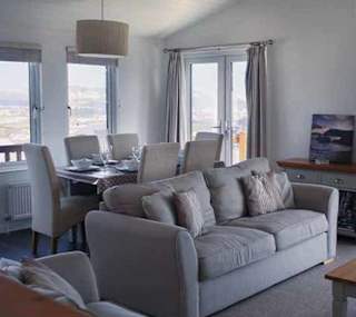 The living area of our bright and spacious Superior Lodge with stunning seaviews. The perfect way to stay. image