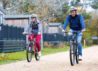 An image of two people cycling through on of our parks together. image