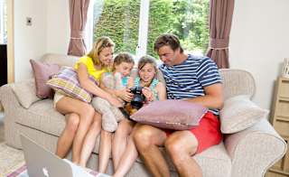 A family enjoying the lounge in our holiday home. image