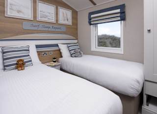 The twin bedroom of one of our spacious static caravans in St Ives. Book your holiday now! image