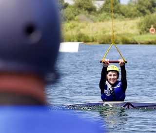 Young boy wakeboarding at our Retallack Resort and Spa, Cornwall.