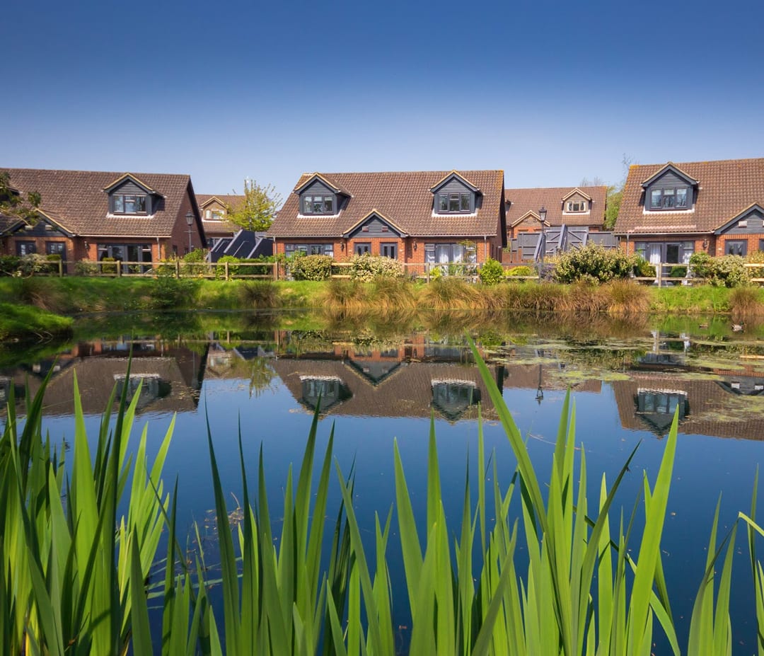 Our holiday homes at The Lakes Rookley holiday park. There are many amazing holiday homes that overlook the lake on this sunny day.