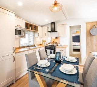 The kitchen and dining area of our bright and spacious luxury static caravan. The perfect way to stay. image