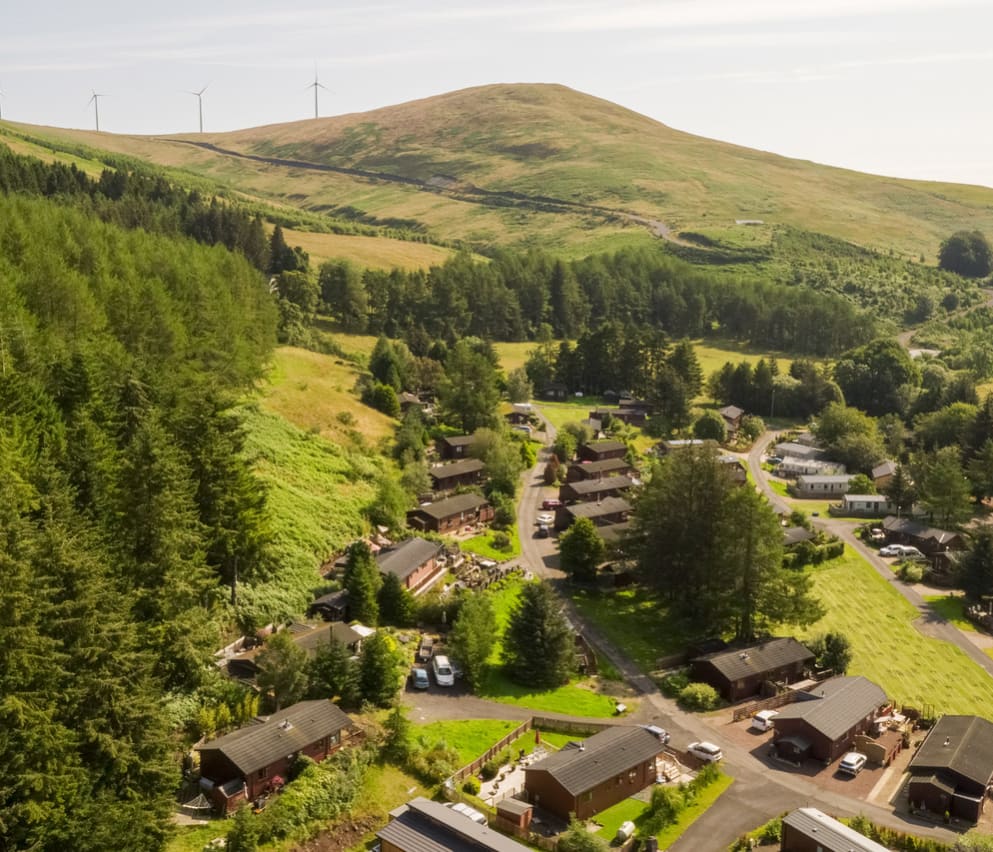 An aerial shot of a selection or holidays homes at Away Resorts Glendevon Residential Park, perched in stunning scenery.