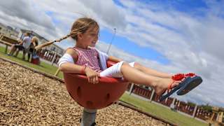 A child playing in the outdoor play area at our holiday park in North Wales, Golden Sands.