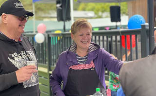 A lifestyle image of two people enjoying an owner's event at our residential country park in Scotland, Glendevon. image