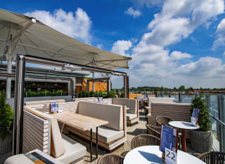 An image of an outdoor seating area on a balconey looking out to the river at one of our holiday parks. image