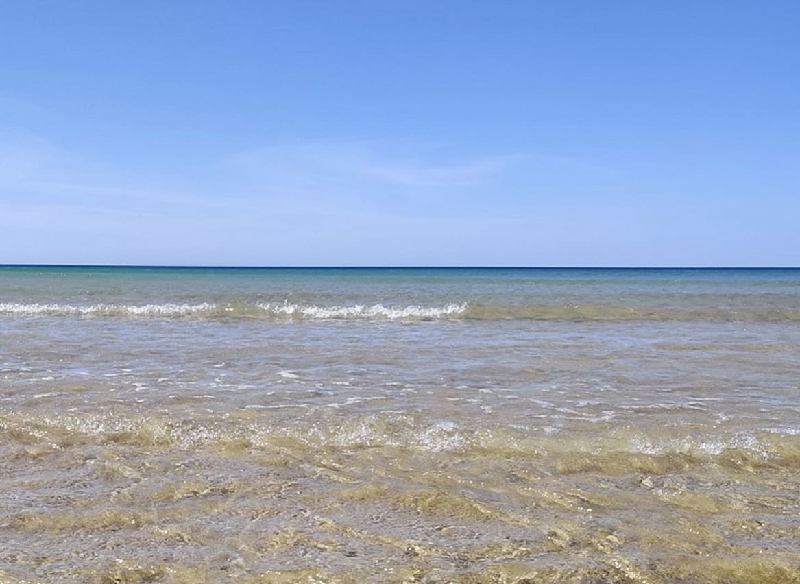 Rolling waves on a bright summers day at a lagoon in Dorset. image