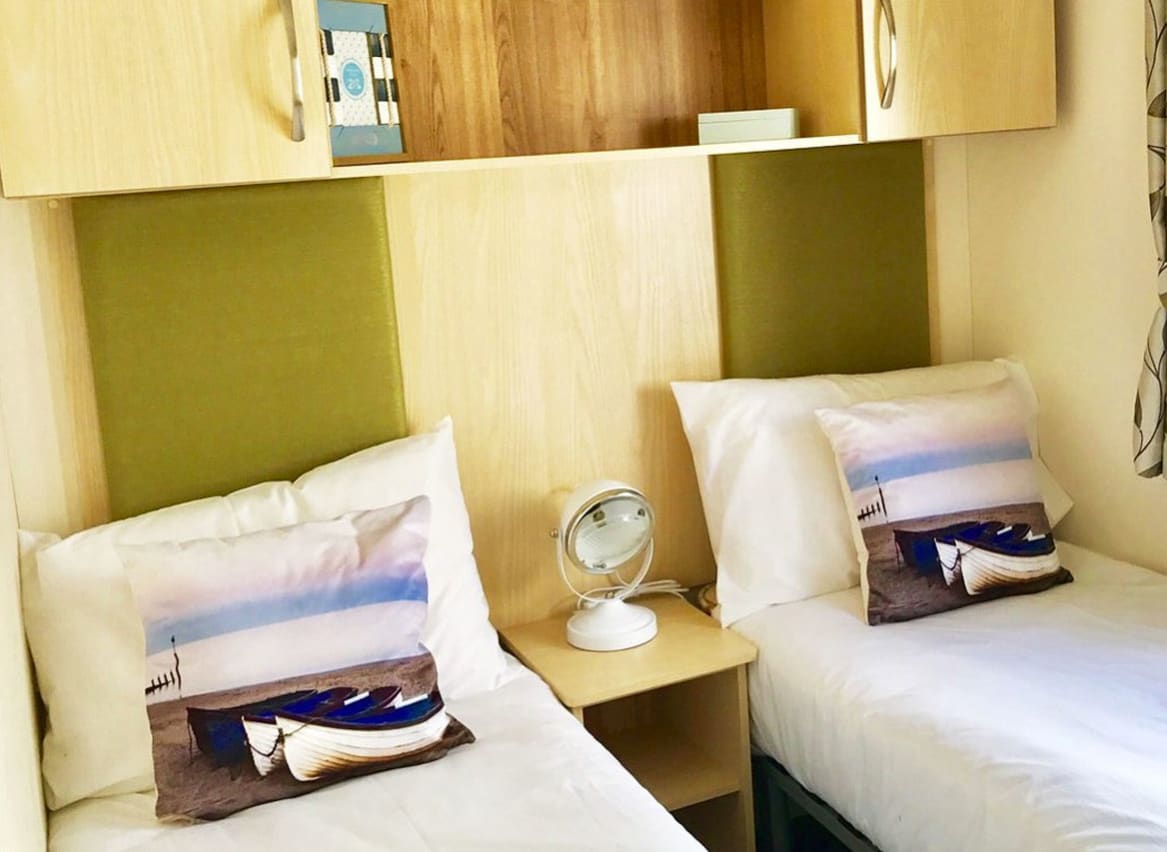 The twin bedroom in our bright and spacious superior static caravan. The perfect way to stay. image